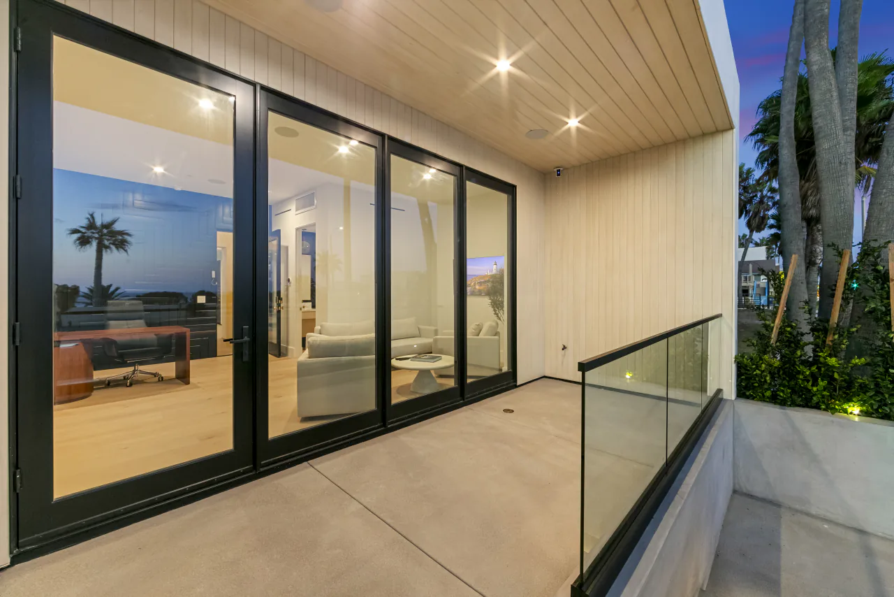 Terrace beside glass sliding doors at dusk